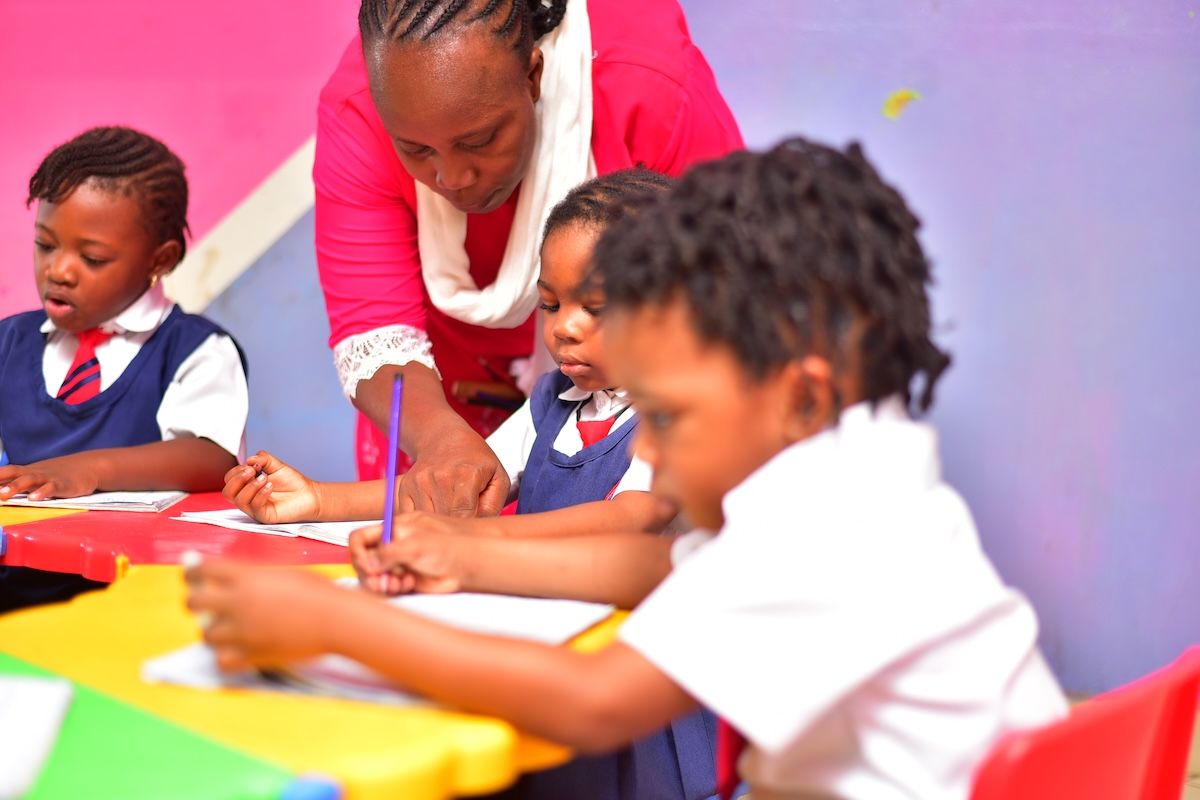 Teacher welcoming pupils at Euston